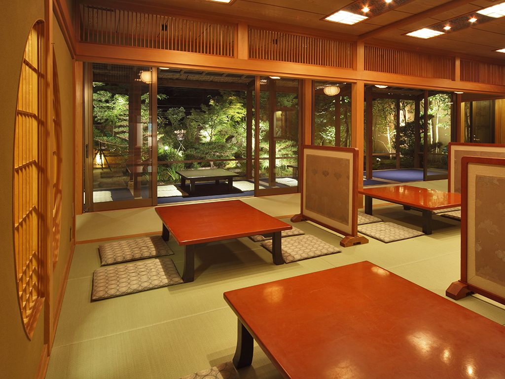 Tatami room overlooking the illuminated Seiryu-tei garden